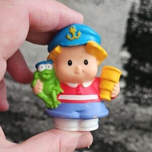 Fisher-Price Little People Eddie Sailor figure holding a frog and a telescope. 
